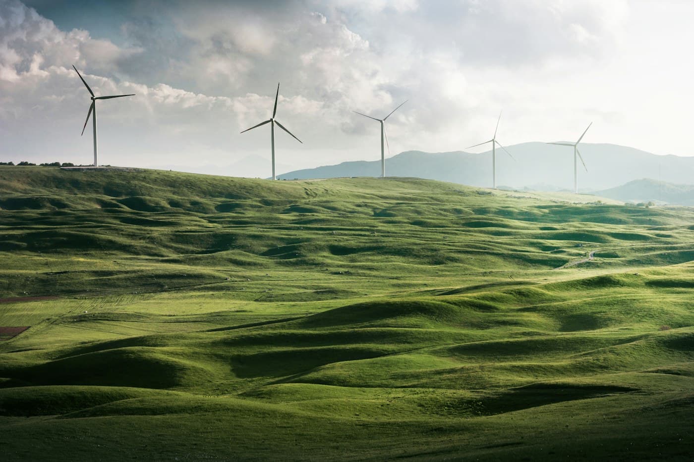 Wind turbines generating clean energy across green hills
